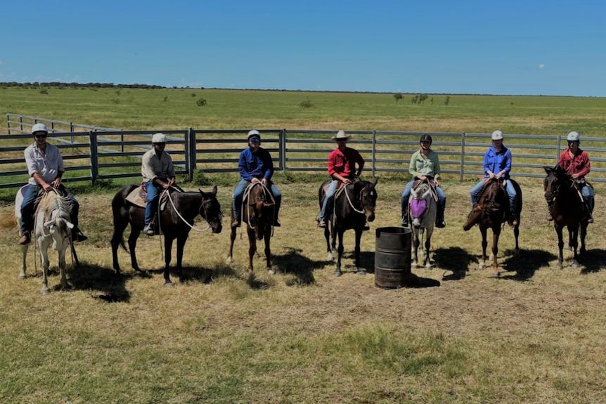 people on horse back in a row