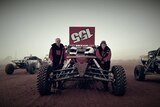 Locky and Paddy Weir standing in front of their buggy on the track for the Finke Desert Race