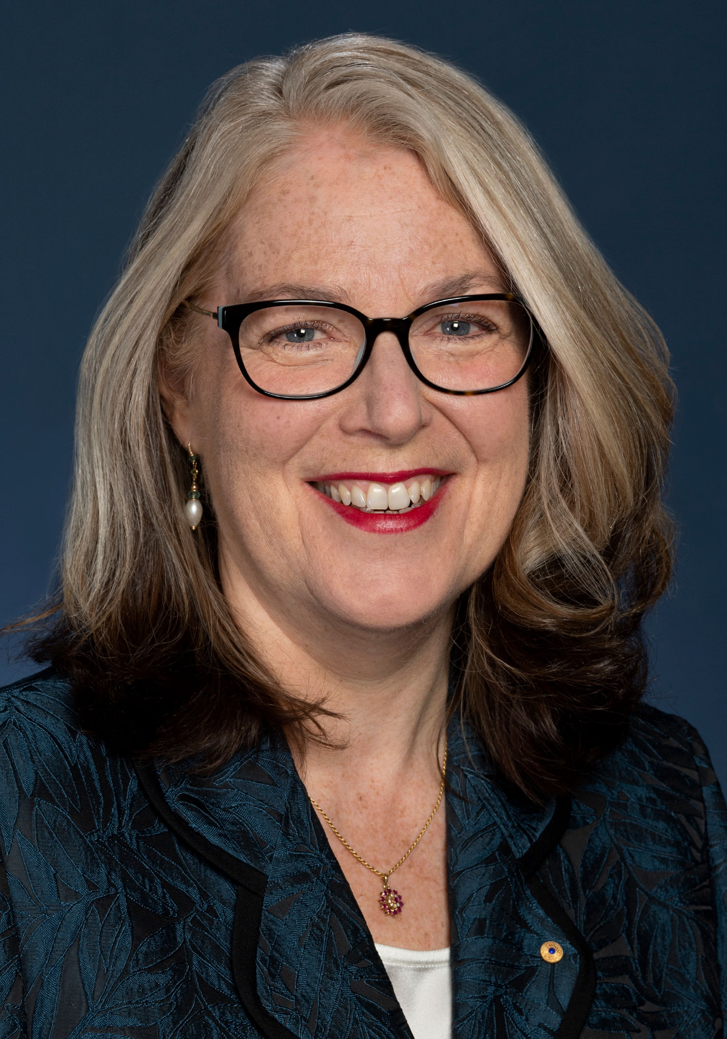 Jan Adams smiles for the camera in an official DFAT portrait