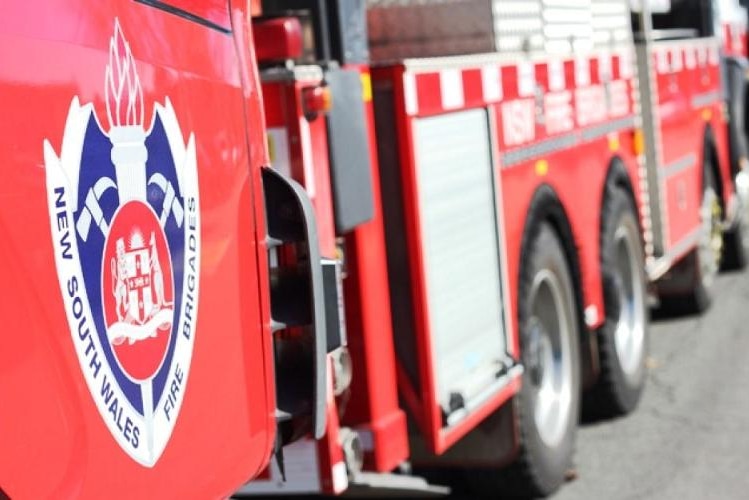 A close up of a Fire and rescue NSW emblem on a fire truck