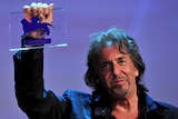 Al Pacino holds the Glory to the Film-maker Award he received at the Venice International Film Festival
