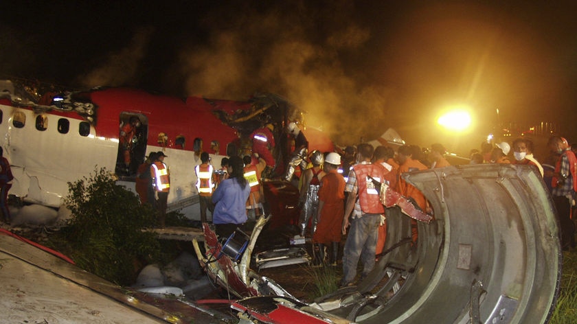 Devastation: Rescue workers pick through the wreckage