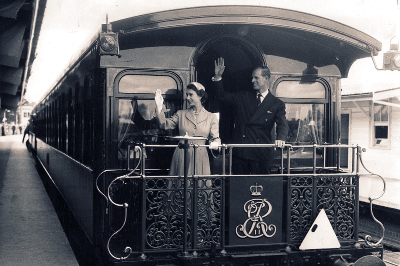 Queen Elizabeth II and the Duke of Edinburgh wave from the Royal train at Bathurst, while on tour in February 1954.