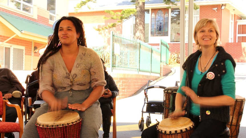 Lesli Hokanson-MacKinnon and Tara Tucker leading the group of elderly residents in African drumming in Glenorchy.
