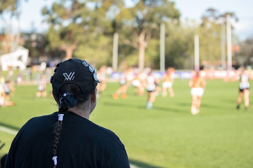 Fearn Harrison watches an AFL match.