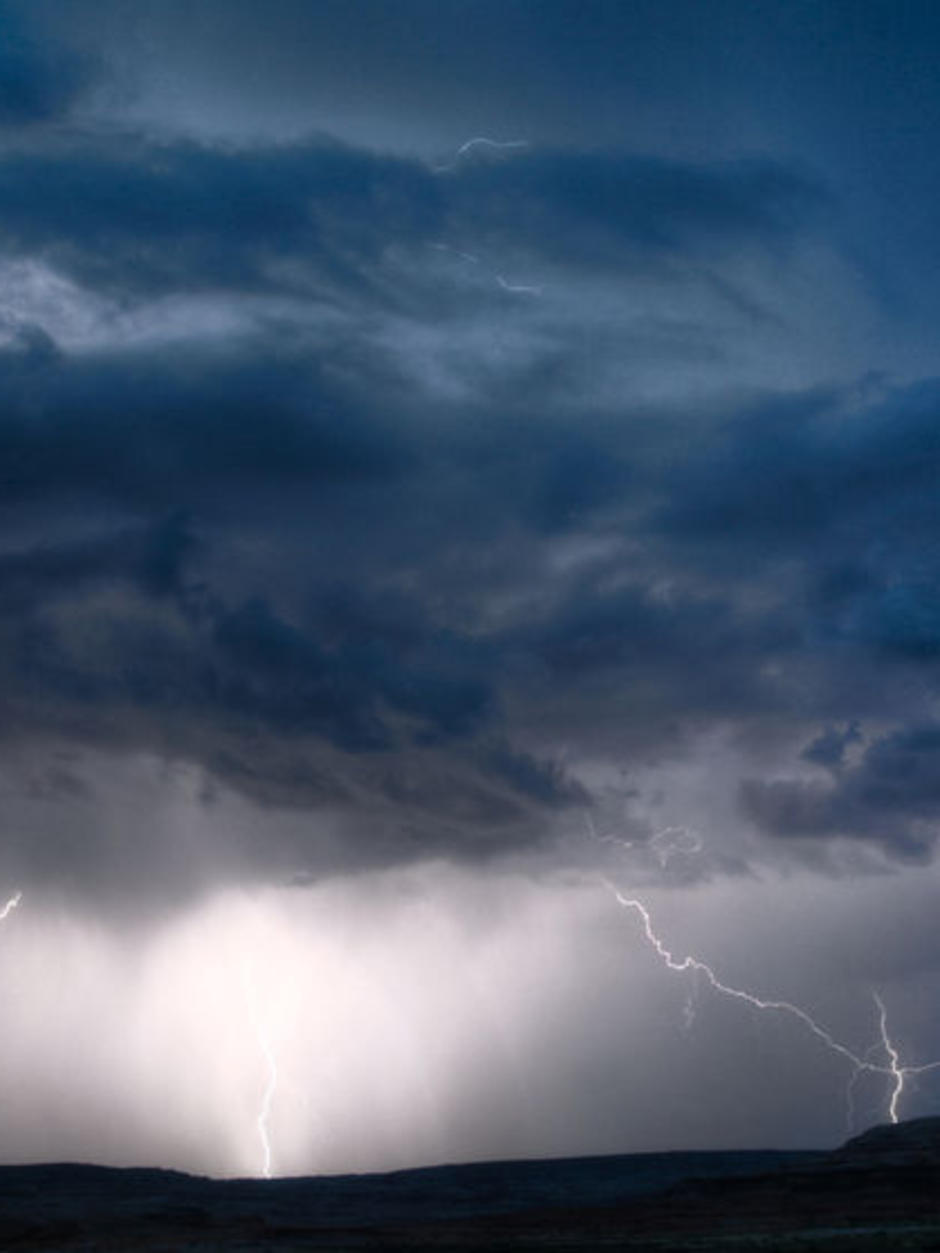 Dark storm clouds and lightning strikes in skies in south-east Queensland.