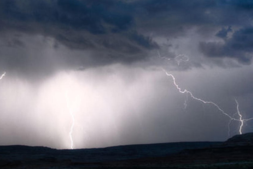 Dark storm clouds and lightning strikes in skies in south-east Queensland.