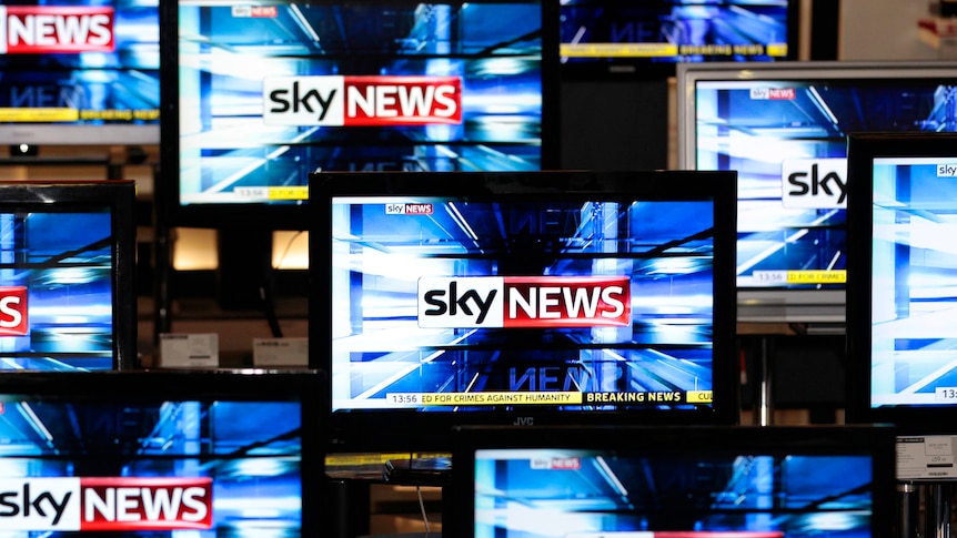 The Sky News logo is seen on television screens