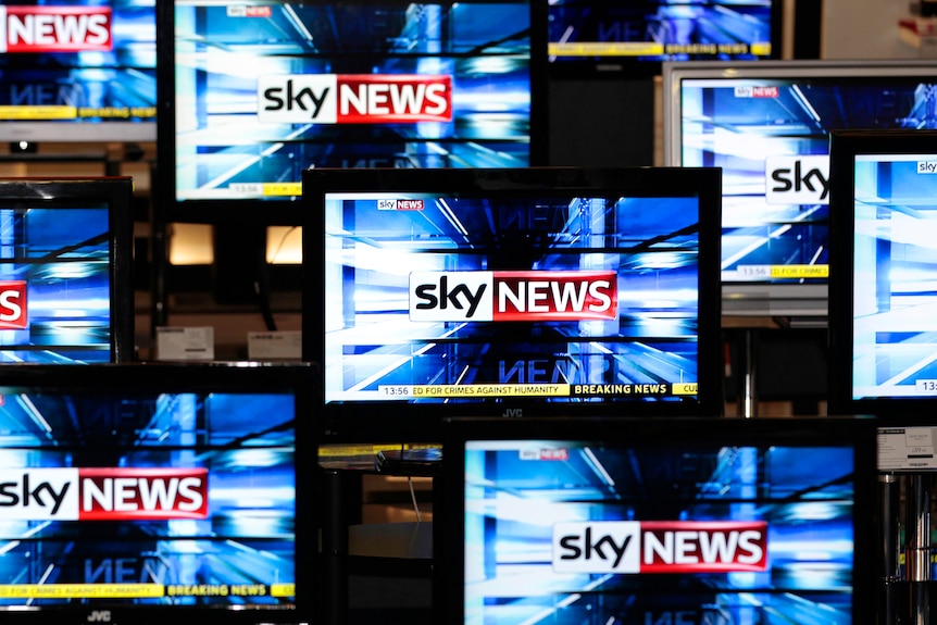 The Sky News logo is seen on television screens