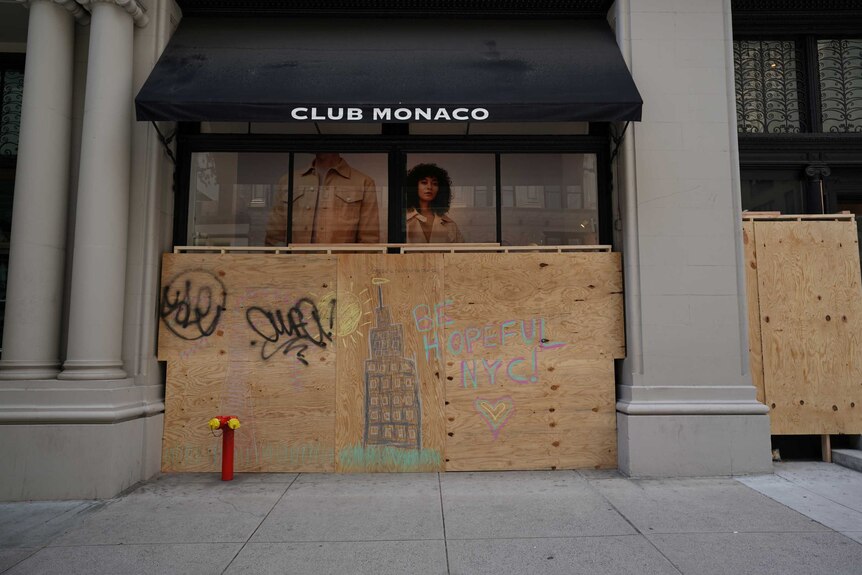 A closed Club Monaco store is covered in plywood, as retail sales suffer record drop during the outbreak.