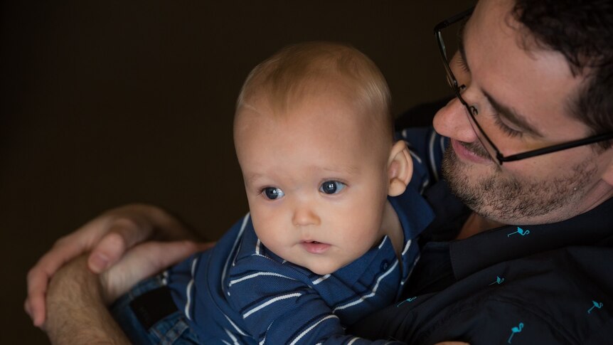 Baby William was conceived by IVF, pictured being cuddled by his father Jared.