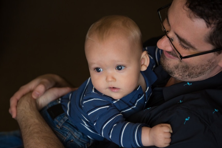 Baby William was conceived by IVF, pictured being cuddled by his father Jared.