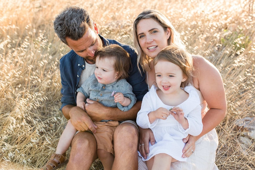 A mother and father with a small boy and girl.