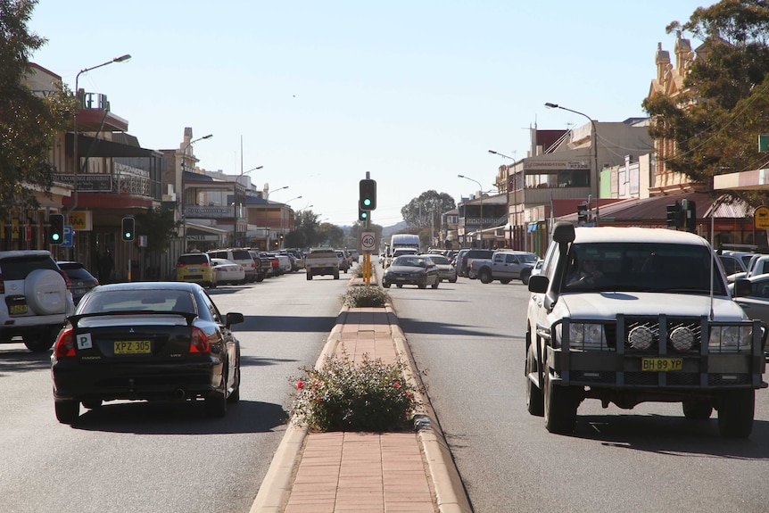 Looking east down Argent Street in Broken Hill from the median strip showing traffic.