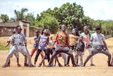 Dancehall enthusiast Alexx Mubanga leads a troupe in dance along a dusty street in Zambia.