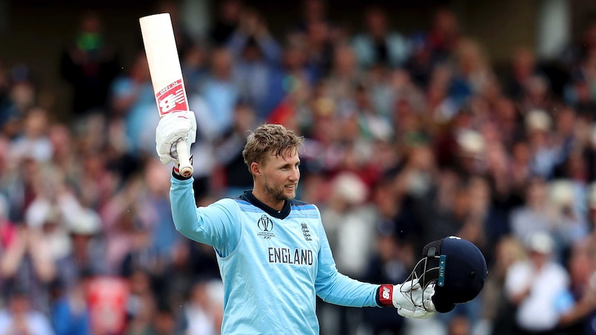 Joe Root raises his bat and waves to the crowd after scoring a century.