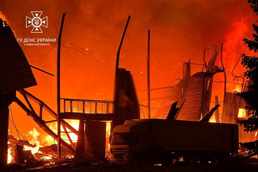 Bright orange flames engulfs a building.