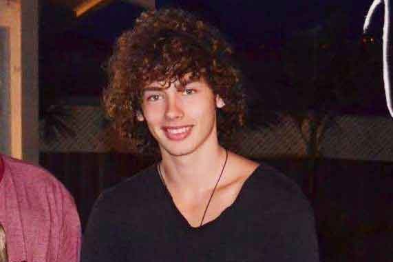 Matthew Ross White smiles in a black t-shirt.