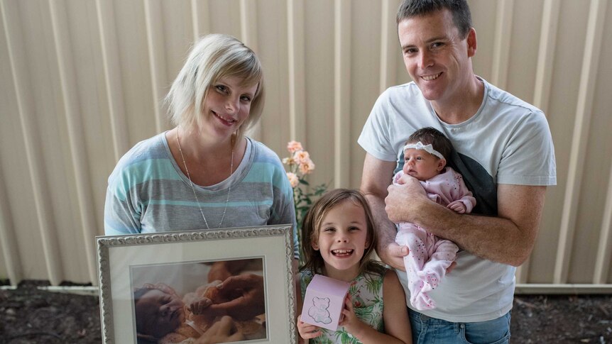 A family shot of the Welsh family which includes a photo of daughter Ellie, who was stillborn.
