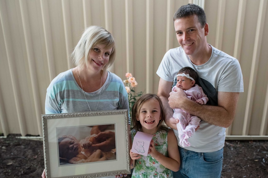 A family shot of the Welsh family which includes a photo of daughter Ellie, who was stillborn.