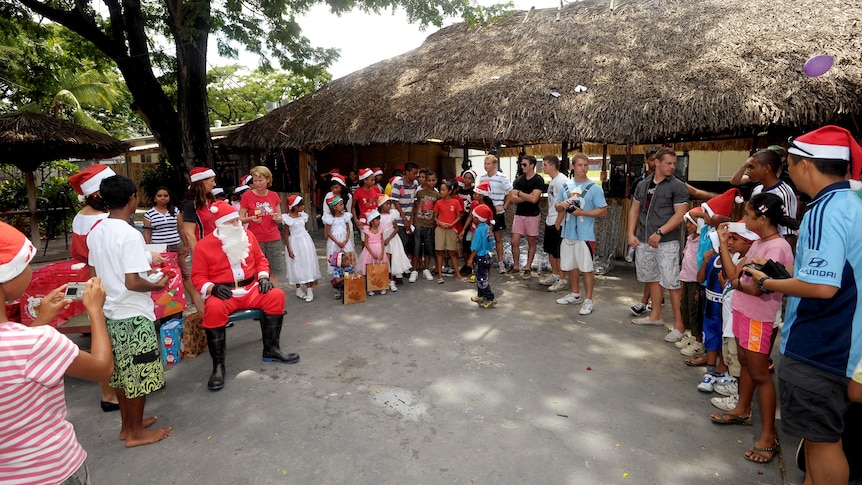 Local East Timorese orphans receive Christmas presents from Santa.