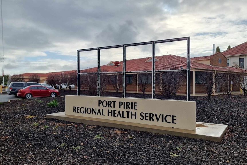 A sign that reads 'Port Pirie Regional Health Service' in front of a one-story building. 