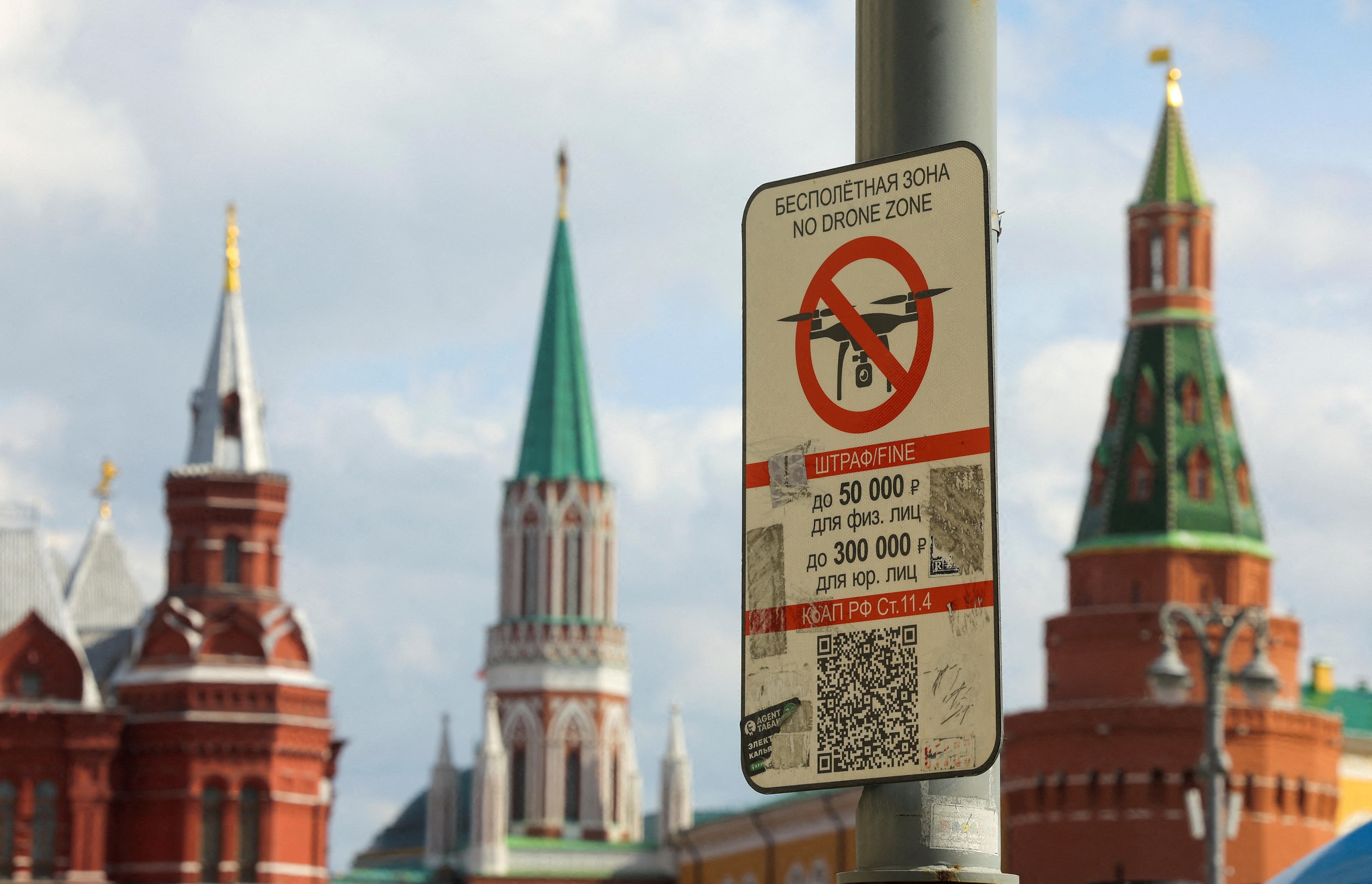 A sign prohibiting unmanned aerial vehicles flying over the area is on display near the Kremlin wall.