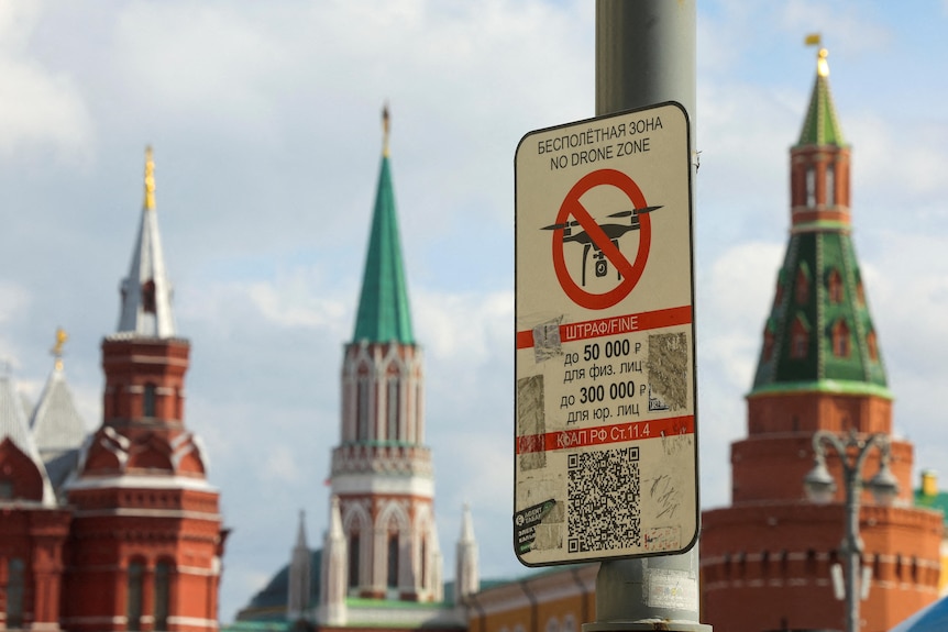 A sign prohibiting unmanned aerial vehicles flying over the area is on display near the Kremlin wall.