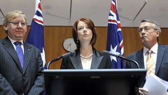 Prime Minister Julia Gillard (centre) announces changes to a mining profits tax with Resources Minister Martin Ferguson (left...