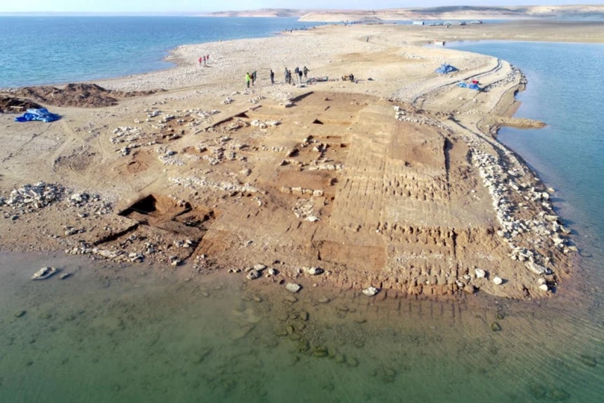 Aerial view of the Kemune excavations with partially submerged Bronze Age architecture in a lake in Iraq.