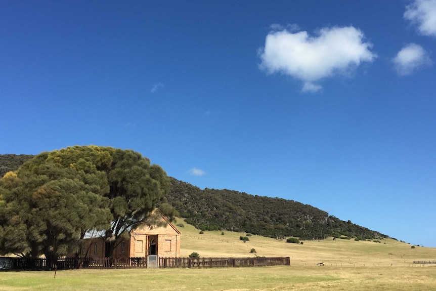 Wybalenna chapel built in 1838 with the Aboriginal graveyard in the background.