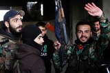 Syrian army soldiers prepare for battle with rebels at the Ramouseh front line, east of Aleppo, Syria, Monday, Dec. 5, 2016