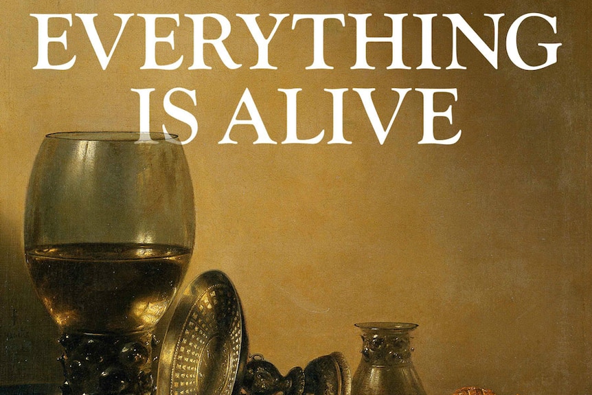 A wine glass, two plates with food on them, and two decorative objects, with 'everything is alive' written above them.