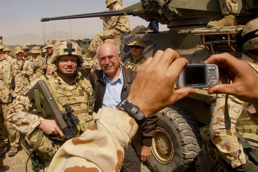 Former prime minister John Howard poses for photos with Australian soldiers