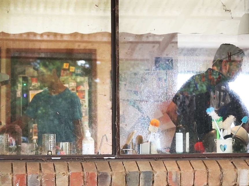 Father and son cooking in the kitchen, seen through the kitchen window