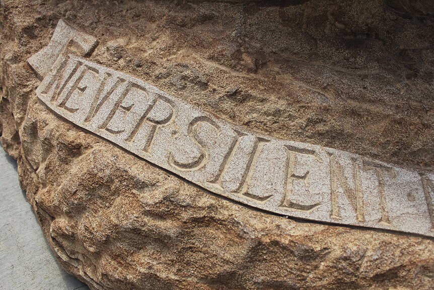 Detail of the monument reads 'never silent'