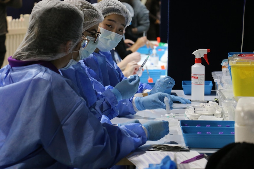 Medical staff prepare Pfizer vaccine shots in Perth
