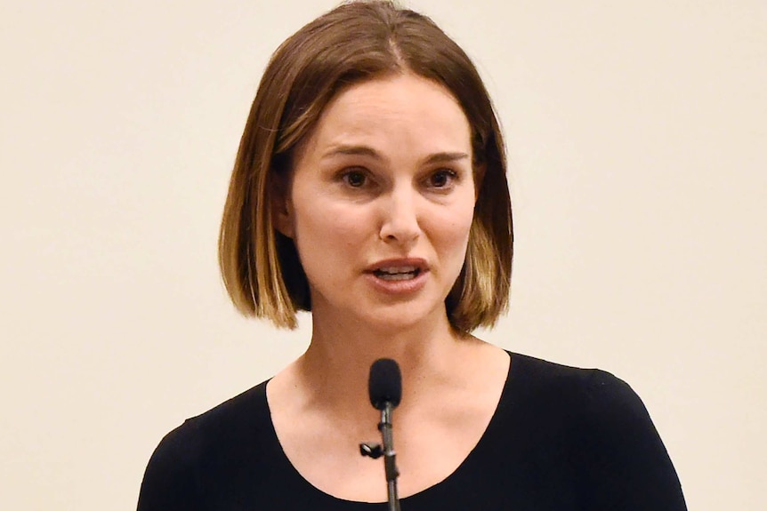 Natalie Portman speaks into a small microphone