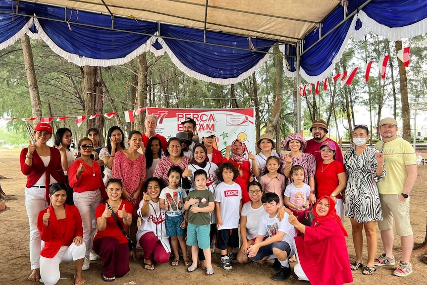 A group of people wearing red celebrating Indonesia's Indepnence Day.