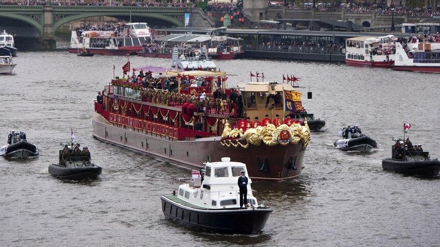The Royal barge, 'Spirit of Chartwell' (C) carrying Britain's Queen Elizabeth II passes the Houses of Parliament
