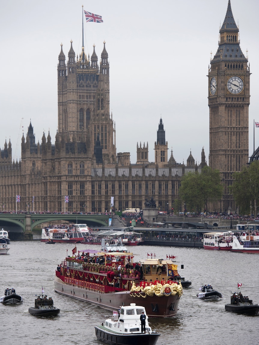 Royal barge 'Spirit of Chartwell' (C) carrying Britain's Queen Elizabeth II passes Houses of Parliament