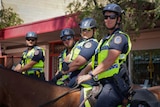 Four police officers on horseback in Alice Springs.