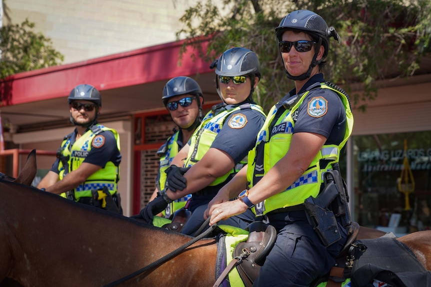 Four police officers on horseback in Alice Springs.