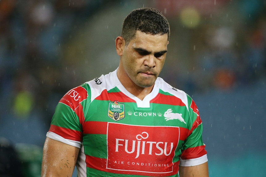 Greg Inglis trudges off in the rain