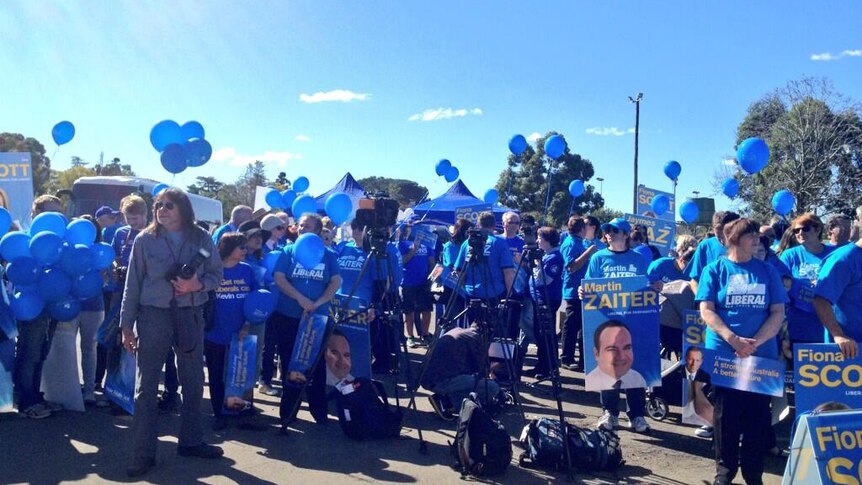 Liberal Party supporters wait for the Tony Abbott western Sydney campaign bus to arrive at Penrith.