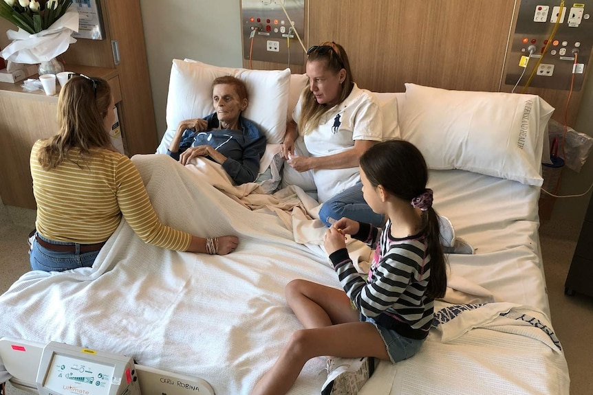 Terminal cancer patient Josephine Collins shares a cuddle bed with her daughters and granddaughter.