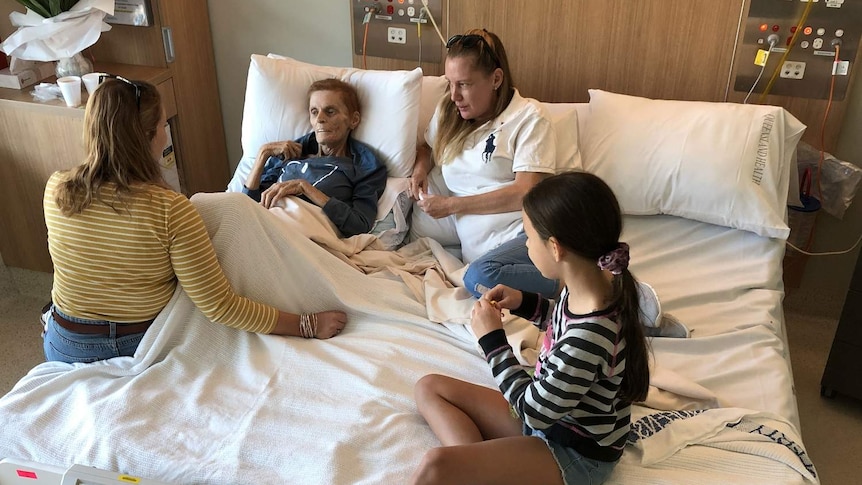 Terminal cancer patient Josephine Collins shares a cuddle bed with her daughters and granddaughter.