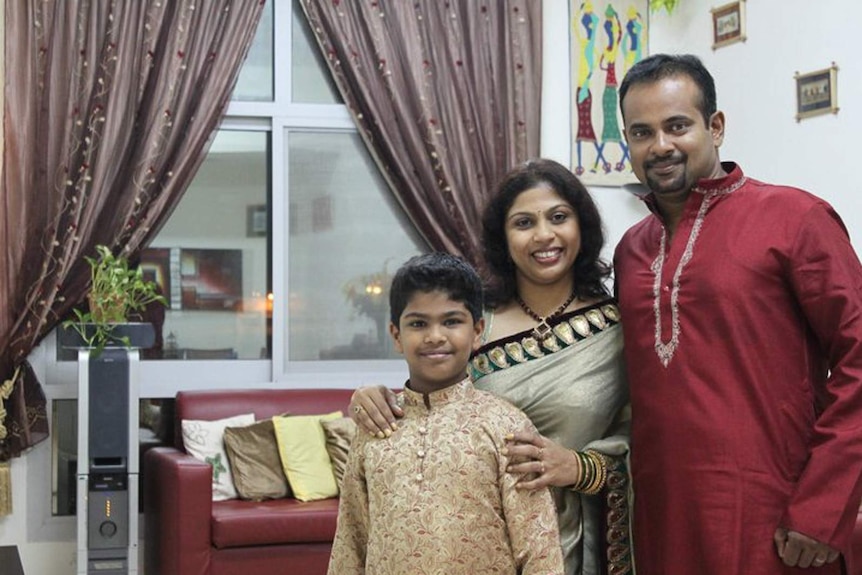 Gaanesh Prasad (R) with his wife and son.