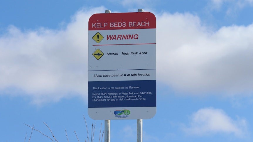 A sign warning people to take care near the Kelp Beds surf break