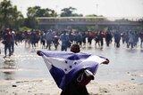 Migrant holds Honduran flag